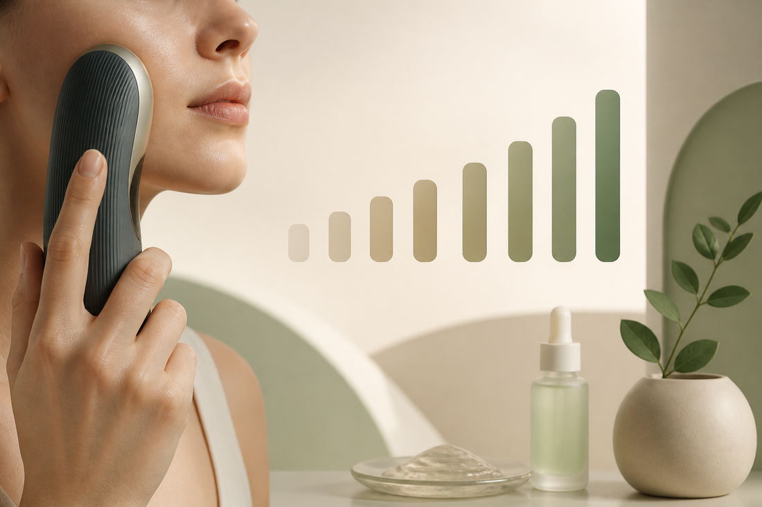 Gentle stepped intensity bars beside a handheld beauty device touching calm skin